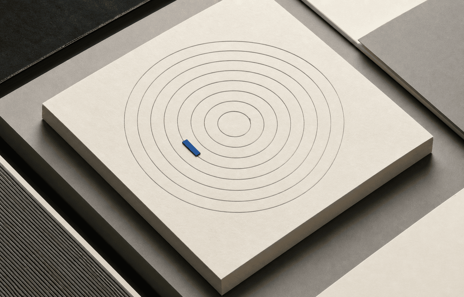 Concentric paper audit rings arranged around a single cobalt measurement marker