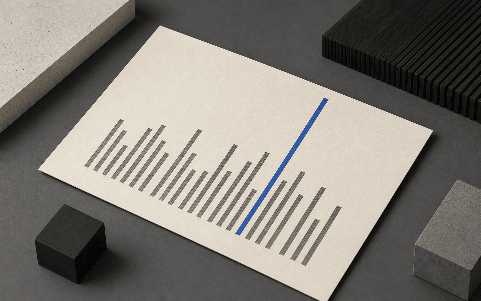 An ivory paper sheet printed with graphite bars of varying height and one cobalt bar standing out